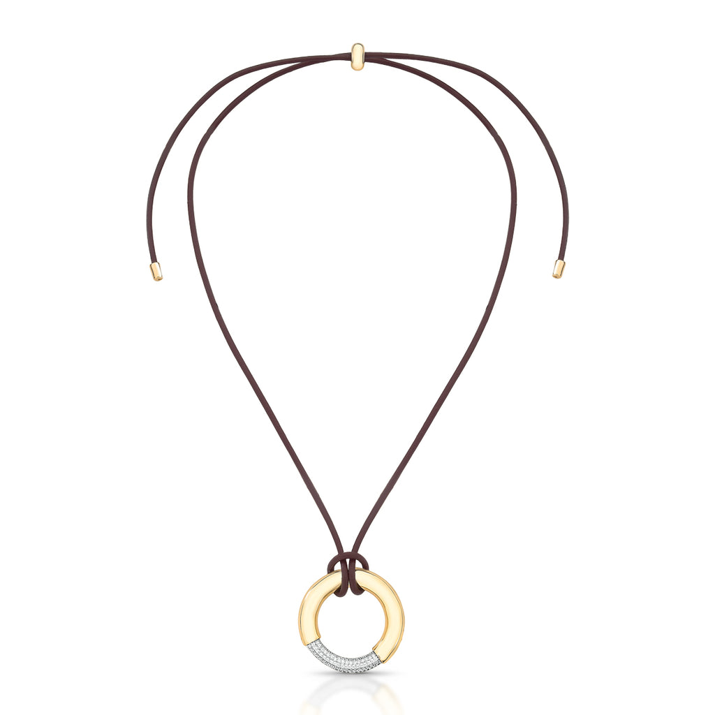 18K gold-plated circle pendant necklace with pavé zirconia on an adjustable brown cord against a white background.