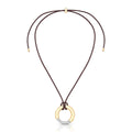 18K gold-plated circle pendant necklace with pavé zirconia on an adjustable brown cord against a white background.