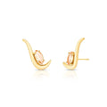 Gold earrings with peach-colored gemstones on a white background