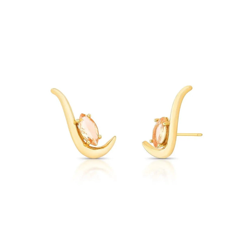 Gold earrings with peach-colored gemstones on a white background