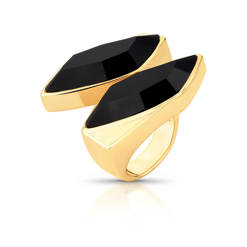 Gold ring with black gemstones on a white background