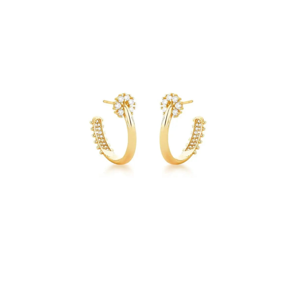Gold hoop earrings with small zirconias on a white background