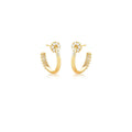 Gold hoop earrings with small zirconias on a white background