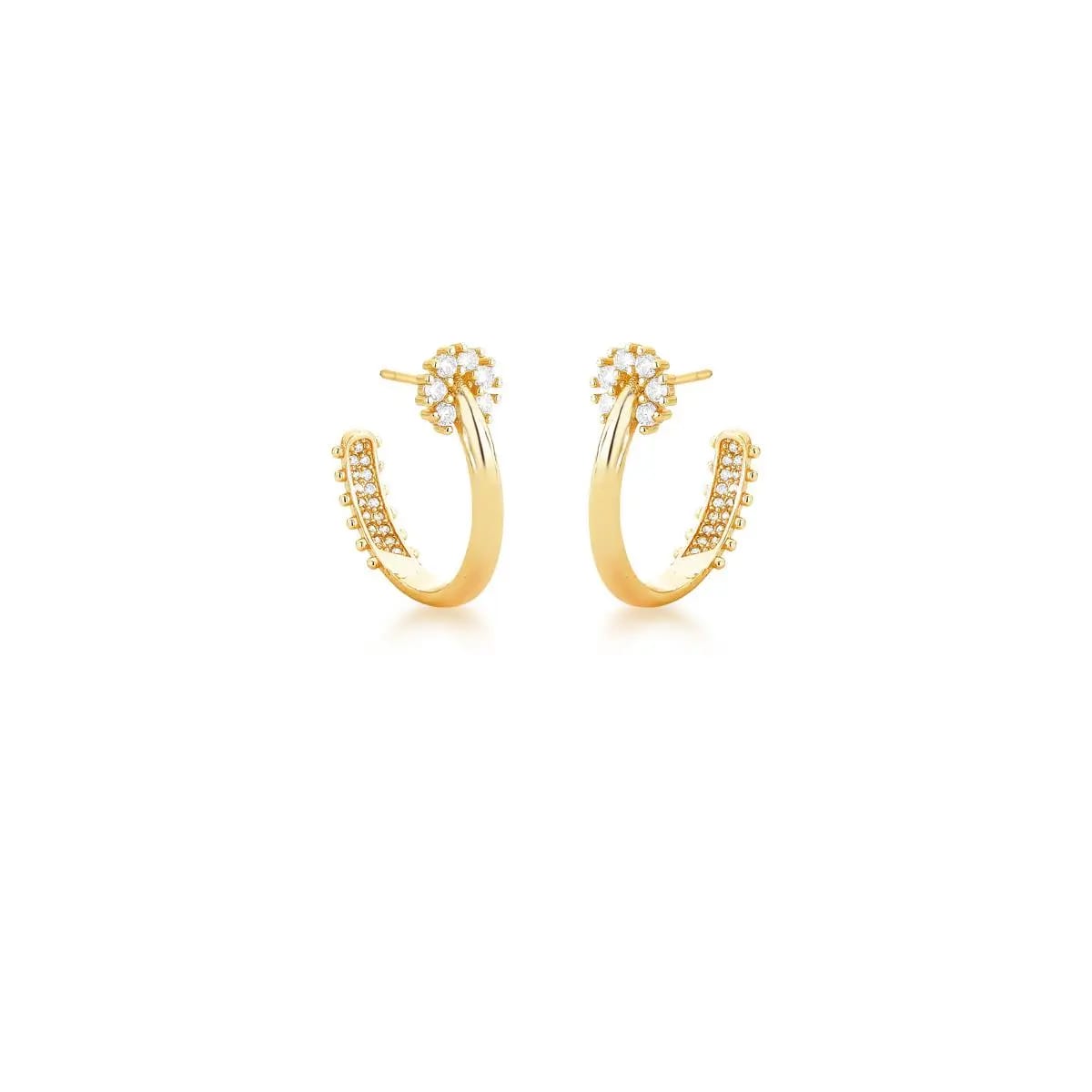 Gold hoop earrings with small zirconias on a white background