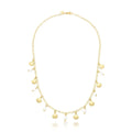 Gold necklace with shell and pearl charms on a white background