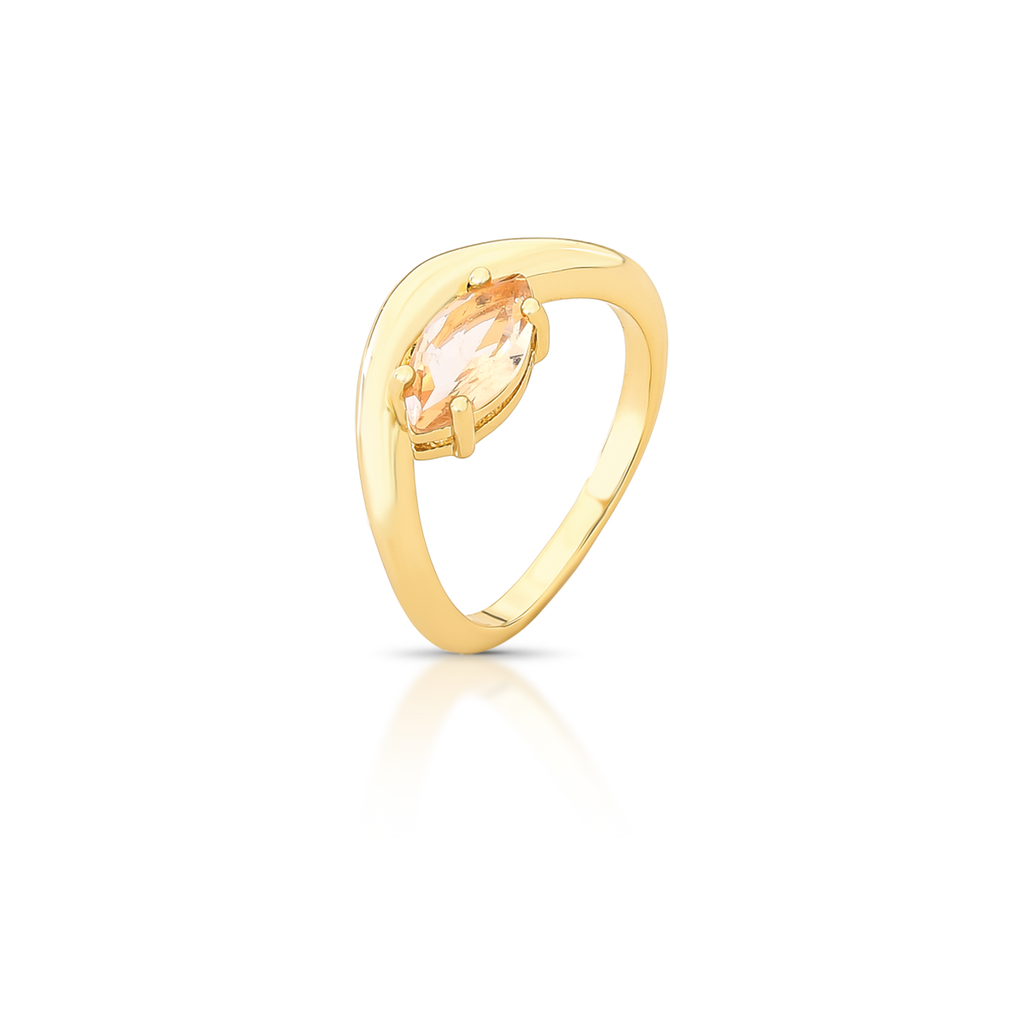 Gold ring with a clear gemstone on a white background