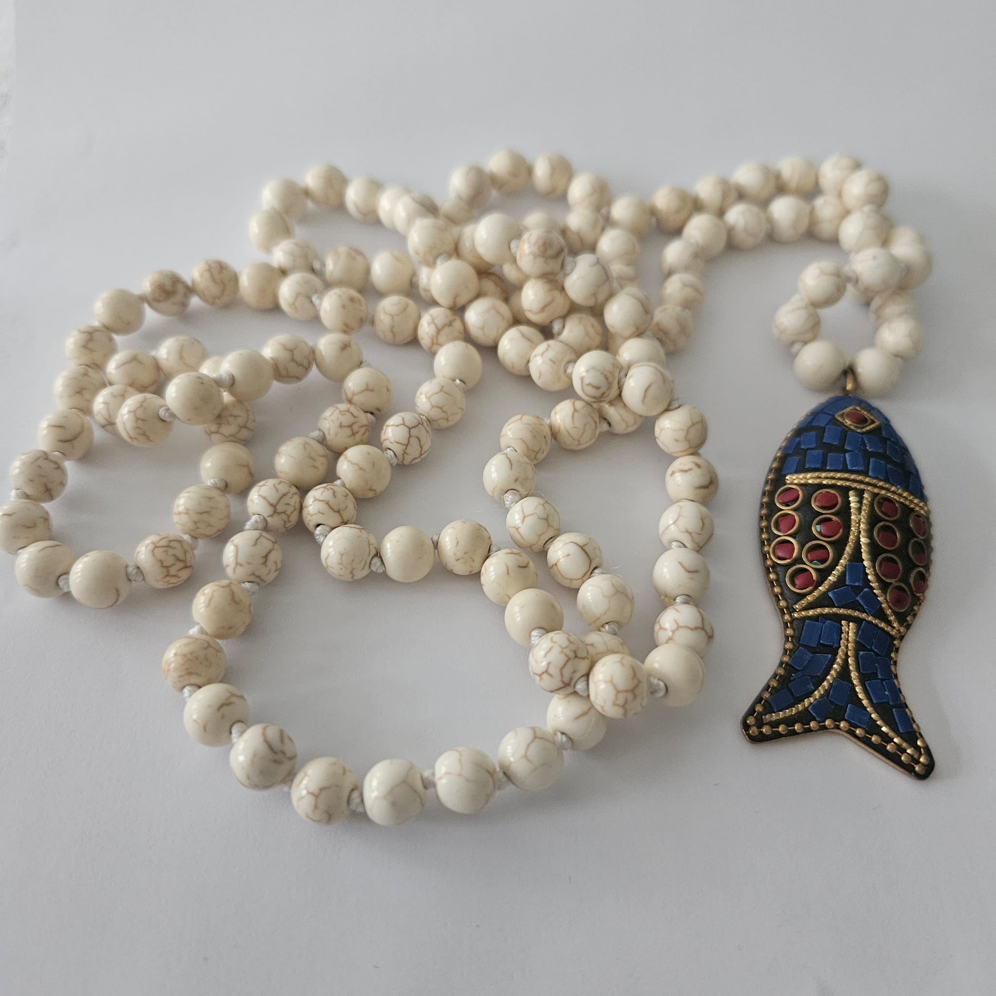 Necklace with a fish pendant