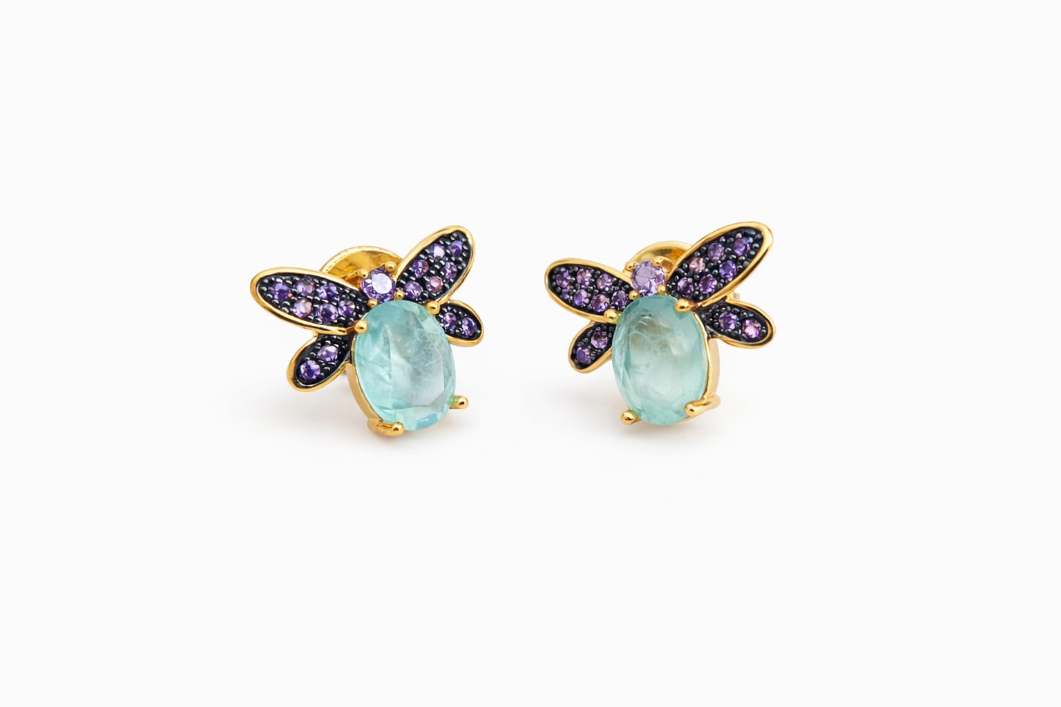 Dragonfly-shaped earrings with gemstones on a white background
