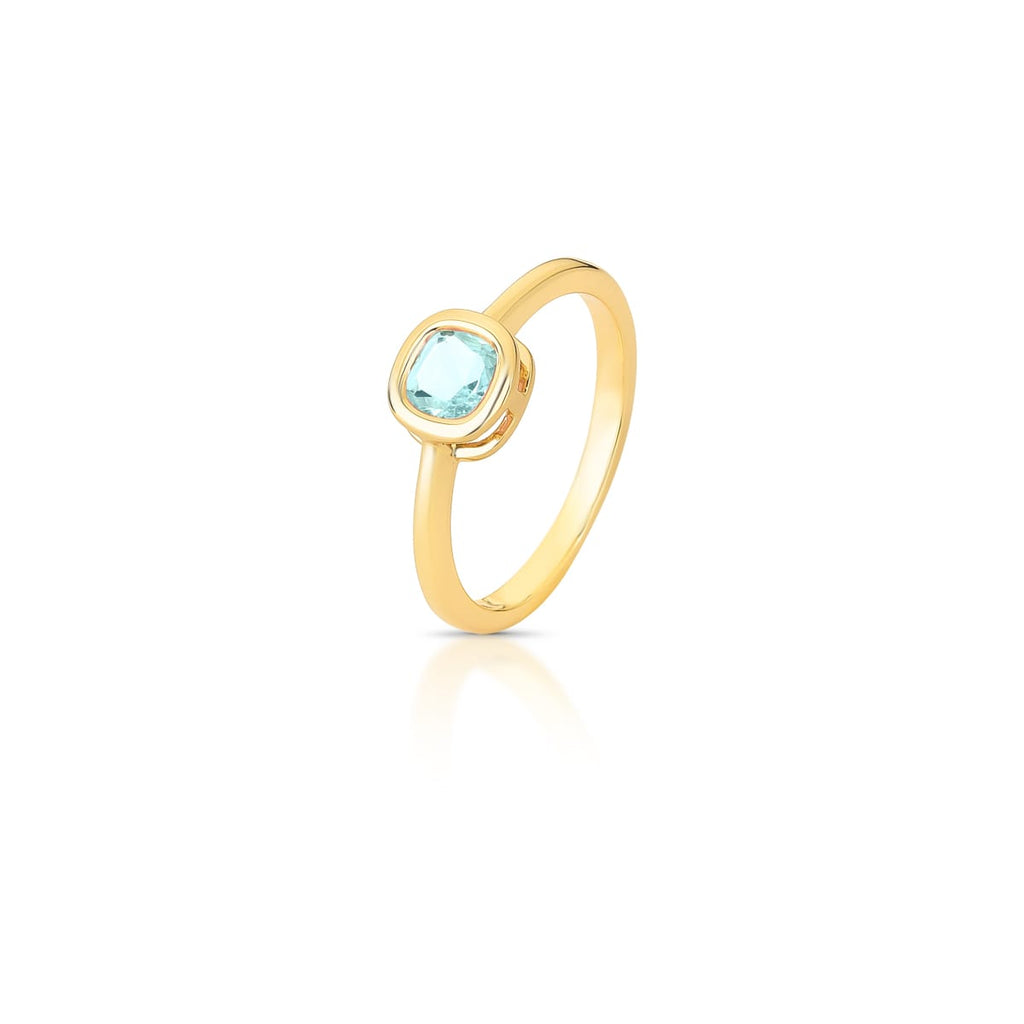 Delicate 18K gold-plated ring featuring a cushion-cut blue crystal in a polished gold setting.